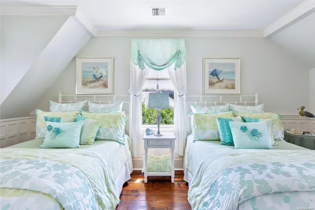 a bed sitting in a bedroom next to a window