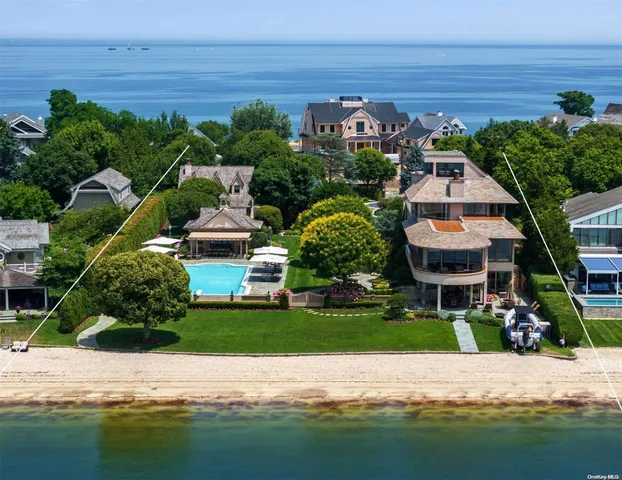 a aerial view of a house with a garden and lake view
