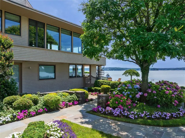 a view of a flower garden in front of house
