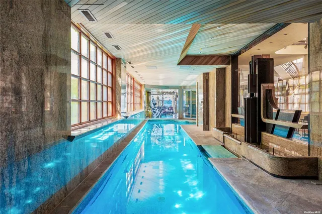 a view of swimming pool with a couches and table