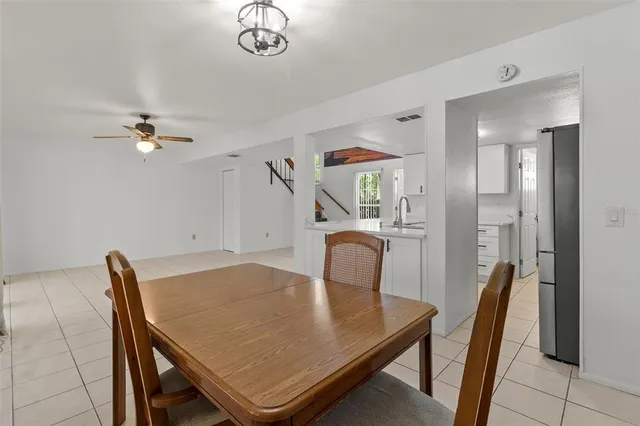 a view of a dining room with furniture and a chandelier
