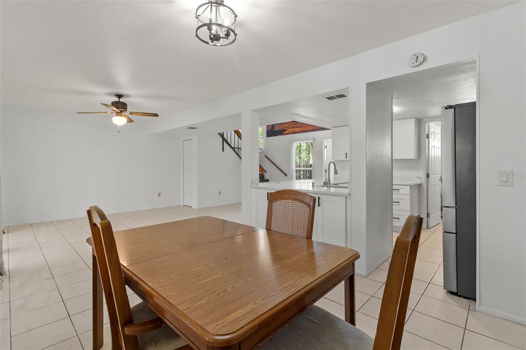 5628 Linksman Place North Port, FL 34287 - Photo 15 of 33 a view of a dining room with furniture and a chandelier