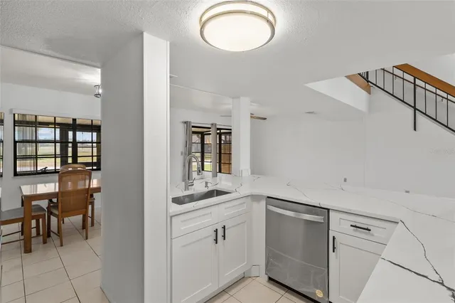 a kitchen with cabinets and window