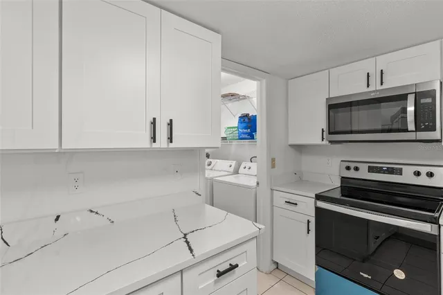 a kitchen with a sink stove and microwave