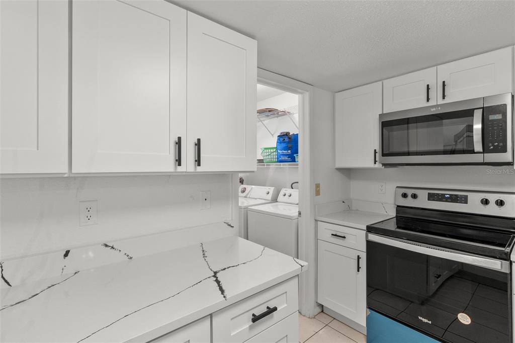 5628 Linksman Place North Port, FL 34287 - Photo 18 of 33 a kitchen with a sink stove and microwave