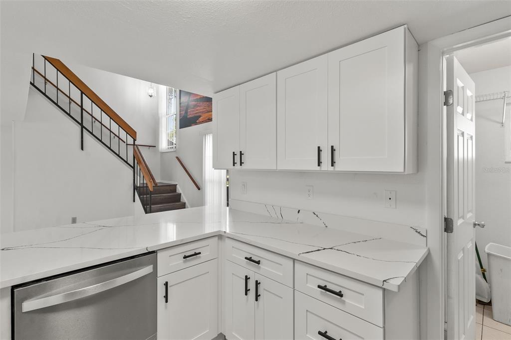 5628 Linksman Place North Port, FL 34287 - Photo 19 of 33 a kitchen with white cabinets and white appliances