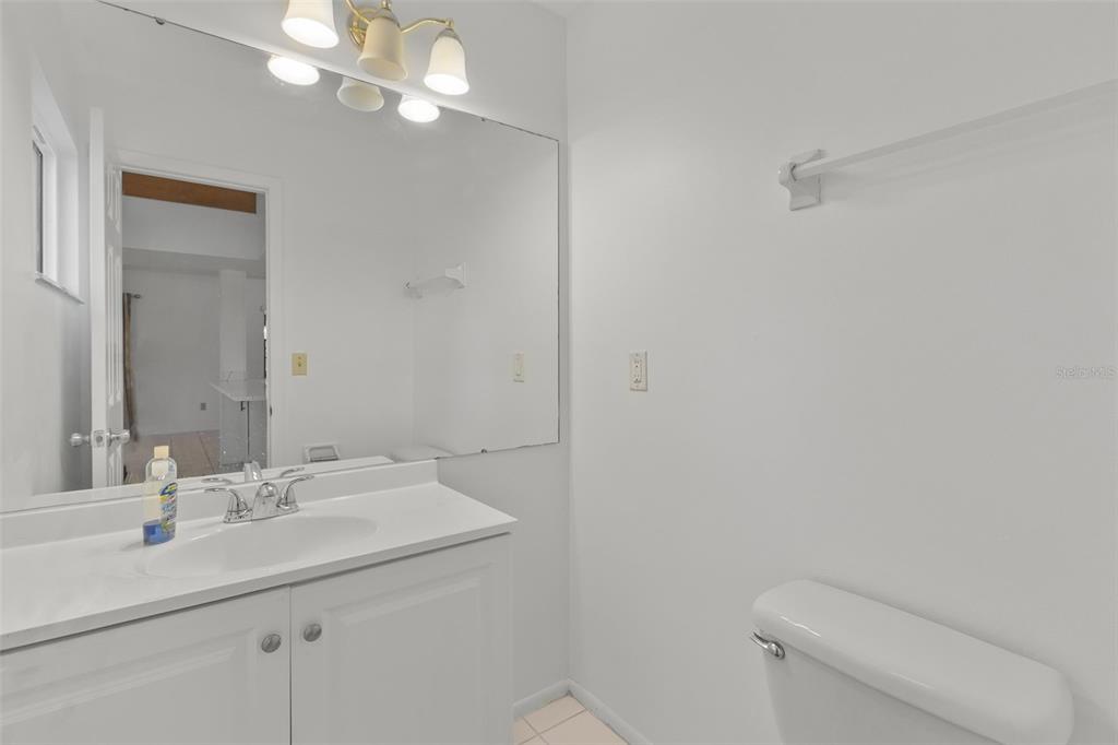 5628 Linksman Place North Port, FL 34287 - Photo 21 of 33 a bathroom with a sink a toilet and a mirror