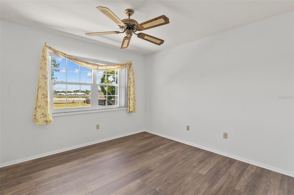 5628 Linksman Place North Port, FL 34287 - Photo 24 of 33 a view of an empty room with wooden floor and a window