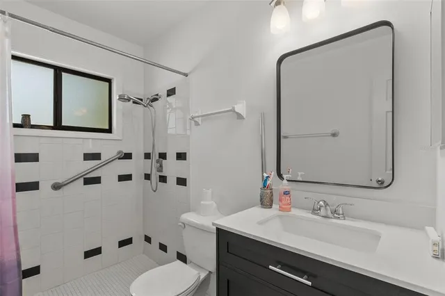 a bathroom with a sink toilet tub and shower