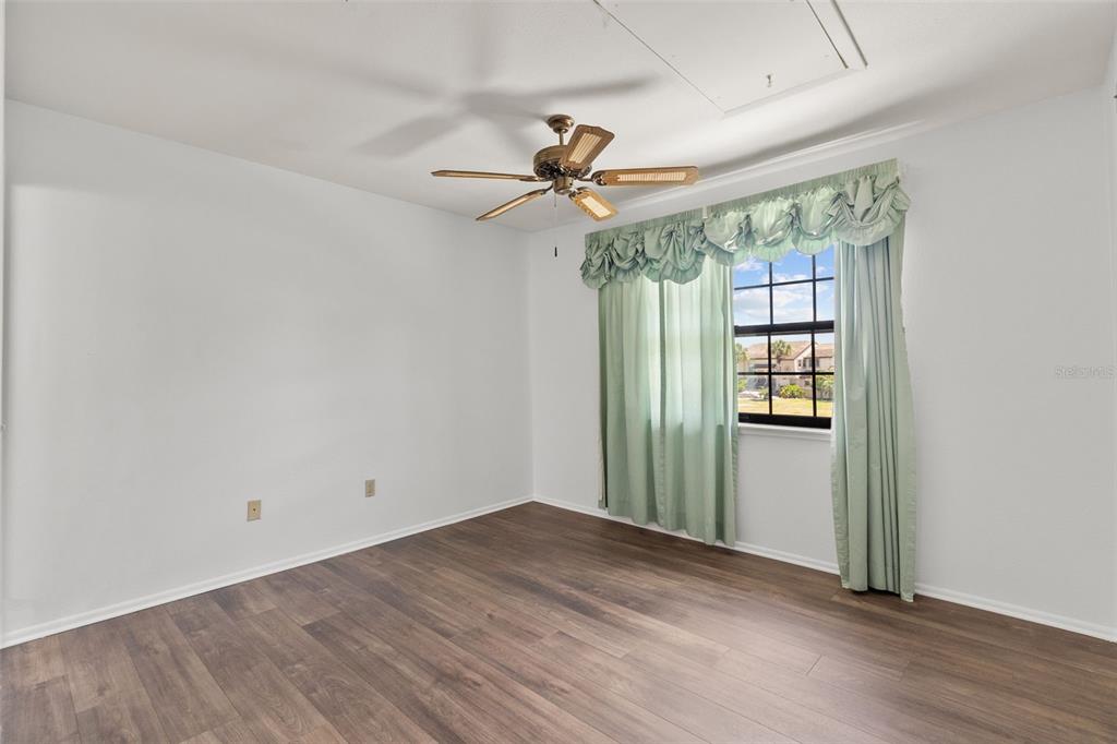 5628 Linksman Place North Port, FL 34287 - Photo 27 of 33 an empty room with windows and fan