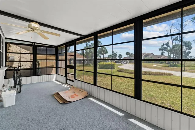 a view of gym with large windows