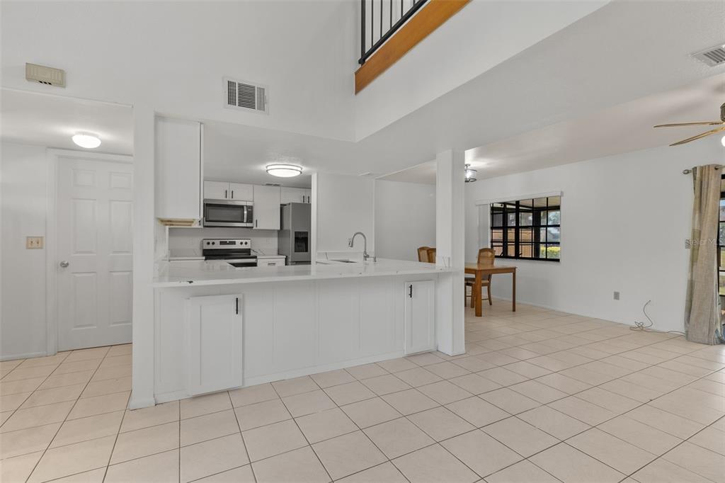5628 Linksman Place North Port, FL 34287 - Photo 6 of 33 a kitchen with white cabinets and appliances