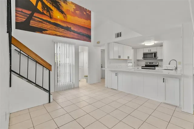 a kitchen with stainless steel appliances granite countertop a refrigerator and a stove top oven