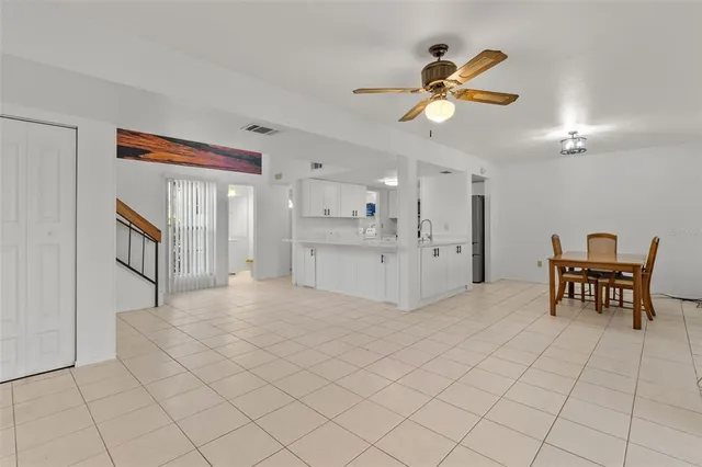 a view of a livingroom with furniture and chandelier fan
