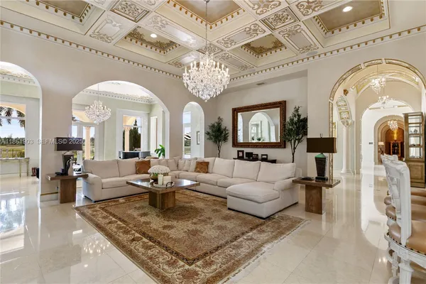 a living room with furniture and a chandelier