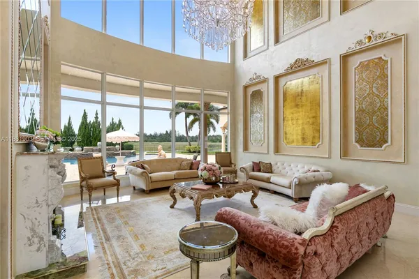 a view of a dining room with furniture and chandelier