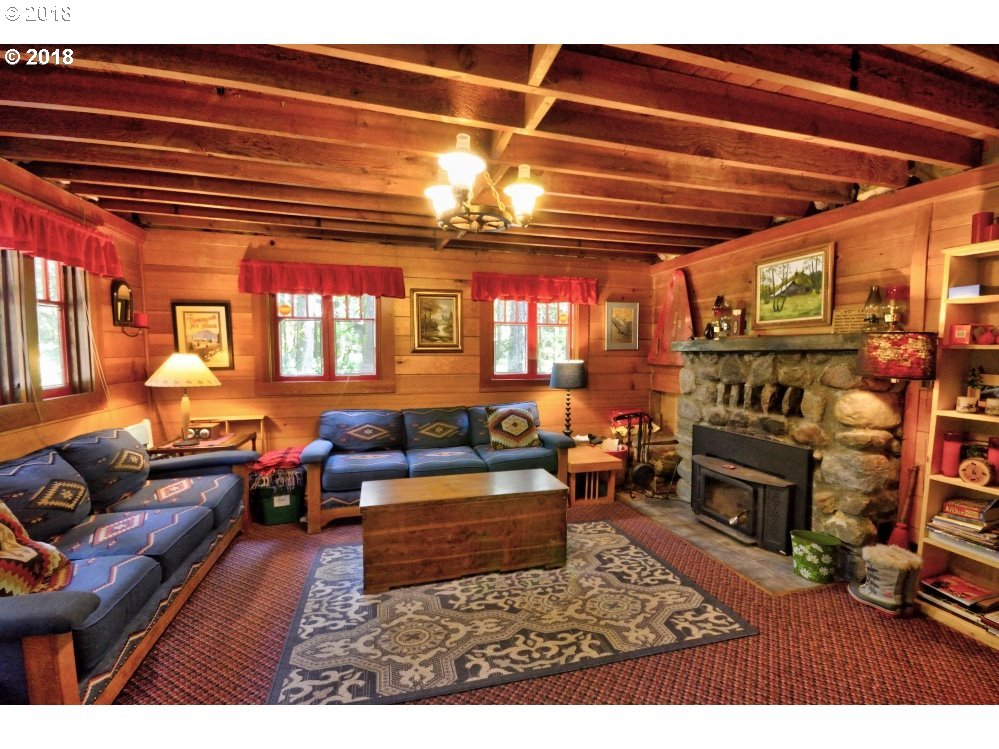 75215 East Road 28 A Rhododendron, OR 97049 - Photo 7 of 27 a living room with furniture a fireplace and a table