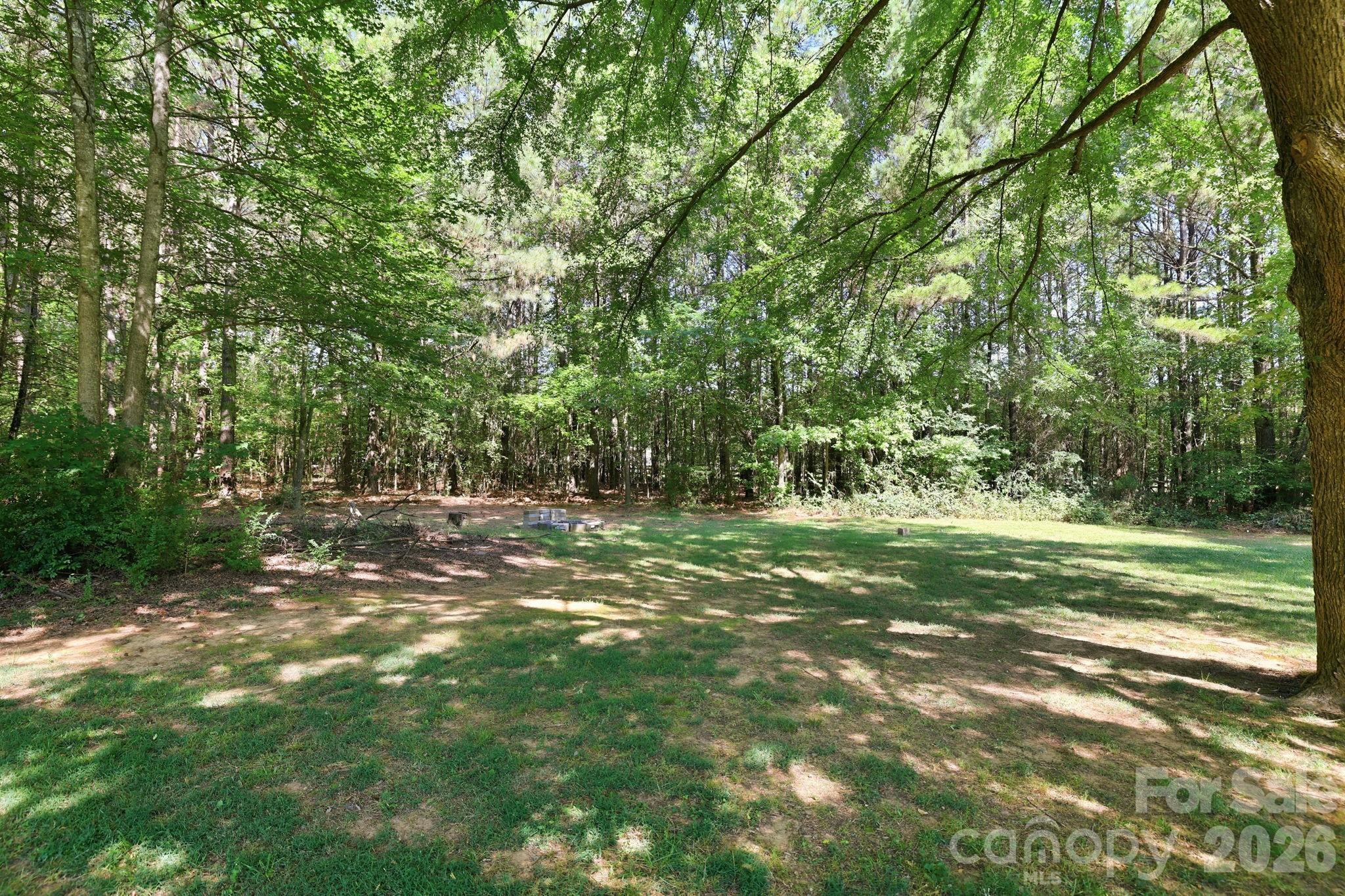 1108 Willoughby Road Monroe, NC 28110 - Photo 26 of 48 a view of a field with a tree