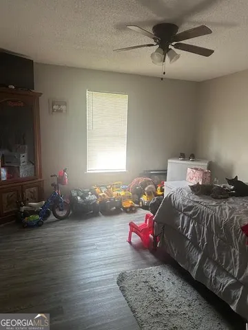 a bedroom with bed couch and window