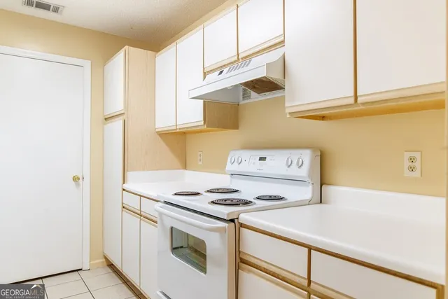 a kitchen with a stove and a microwave
