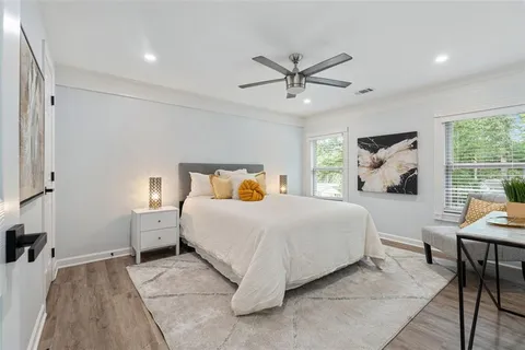a bedroom with a large bed and a chandelier