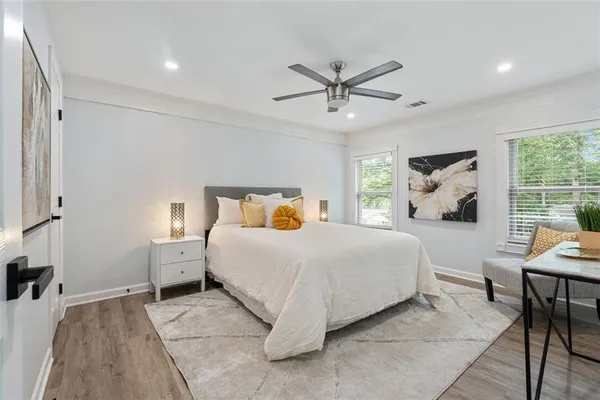 a bedroom with a large bed and a chandelier