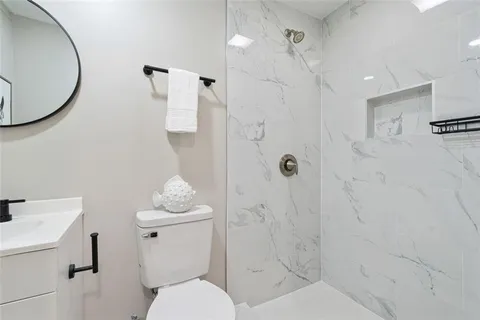 a bathroom with a toilet a sink and a shower