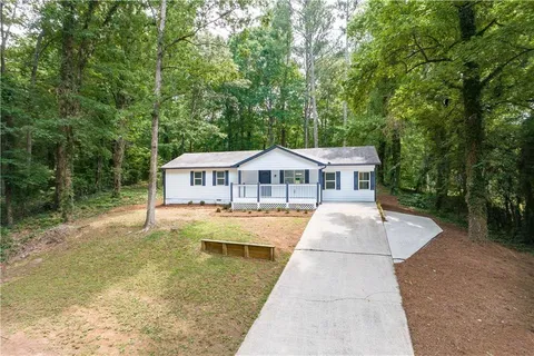 a house with swimming pool in front of it