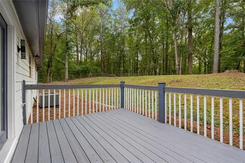a balcony with wooden floor and fence