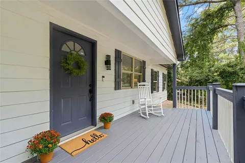 a view of a two chairs and table in patio with potted plants