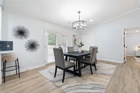 a view of a dining room with furniture wooden floor and chandelier