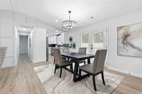 a view of a dining room with furniture wooden floor and a chandelier