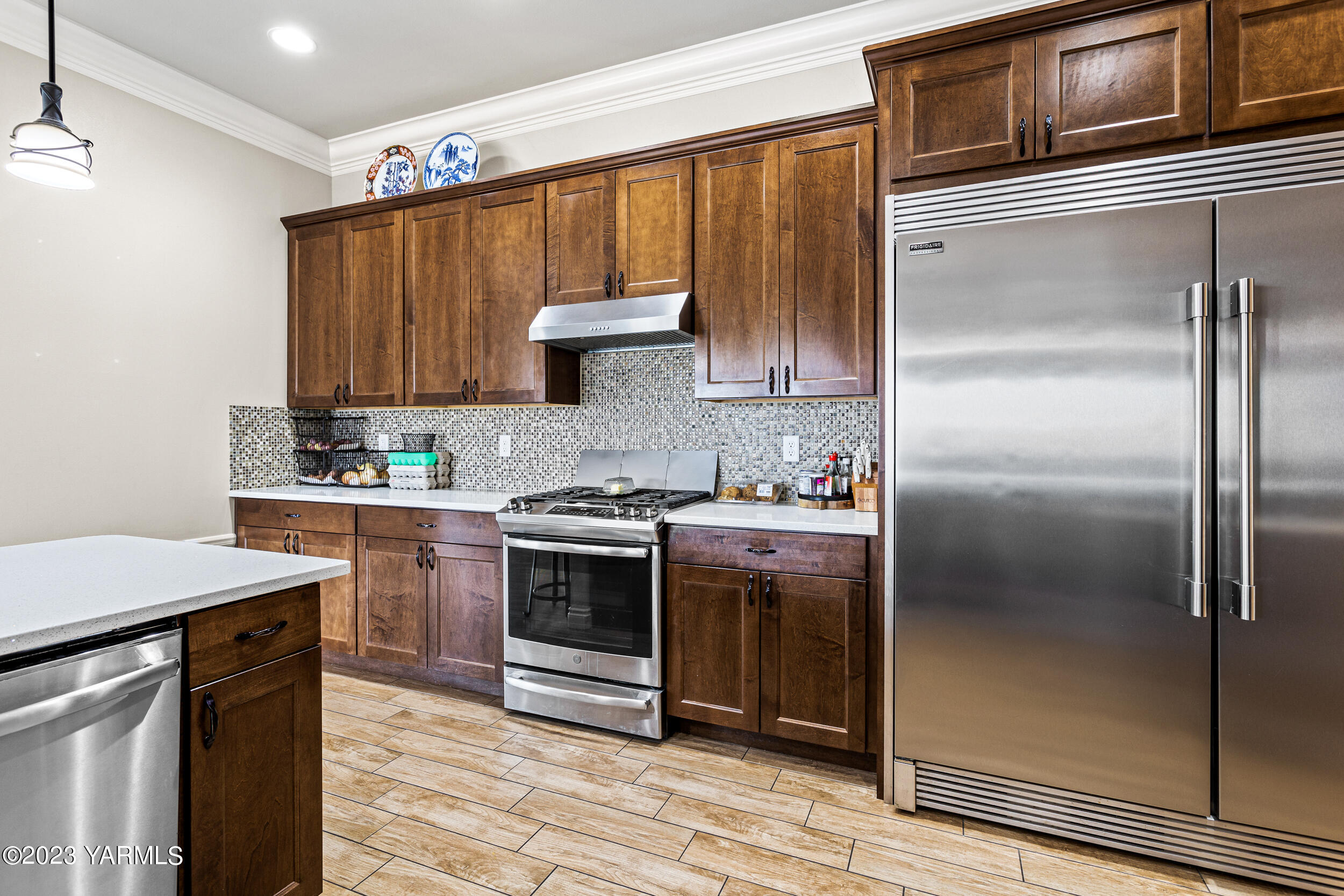245 West Huntzinger Road Selah, WA 98942 - Photo 6 of 54 a kitchen with kitchen island granite countertop a stove and a refrigerator