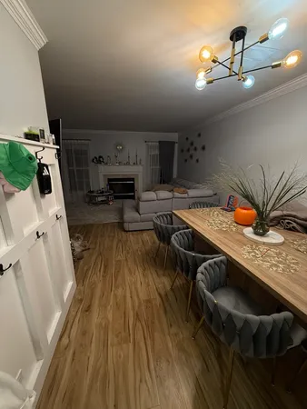 a kitchen with stainless steel appliances granite countertop a stove a sink dishwasher and cabinets with wooden floor