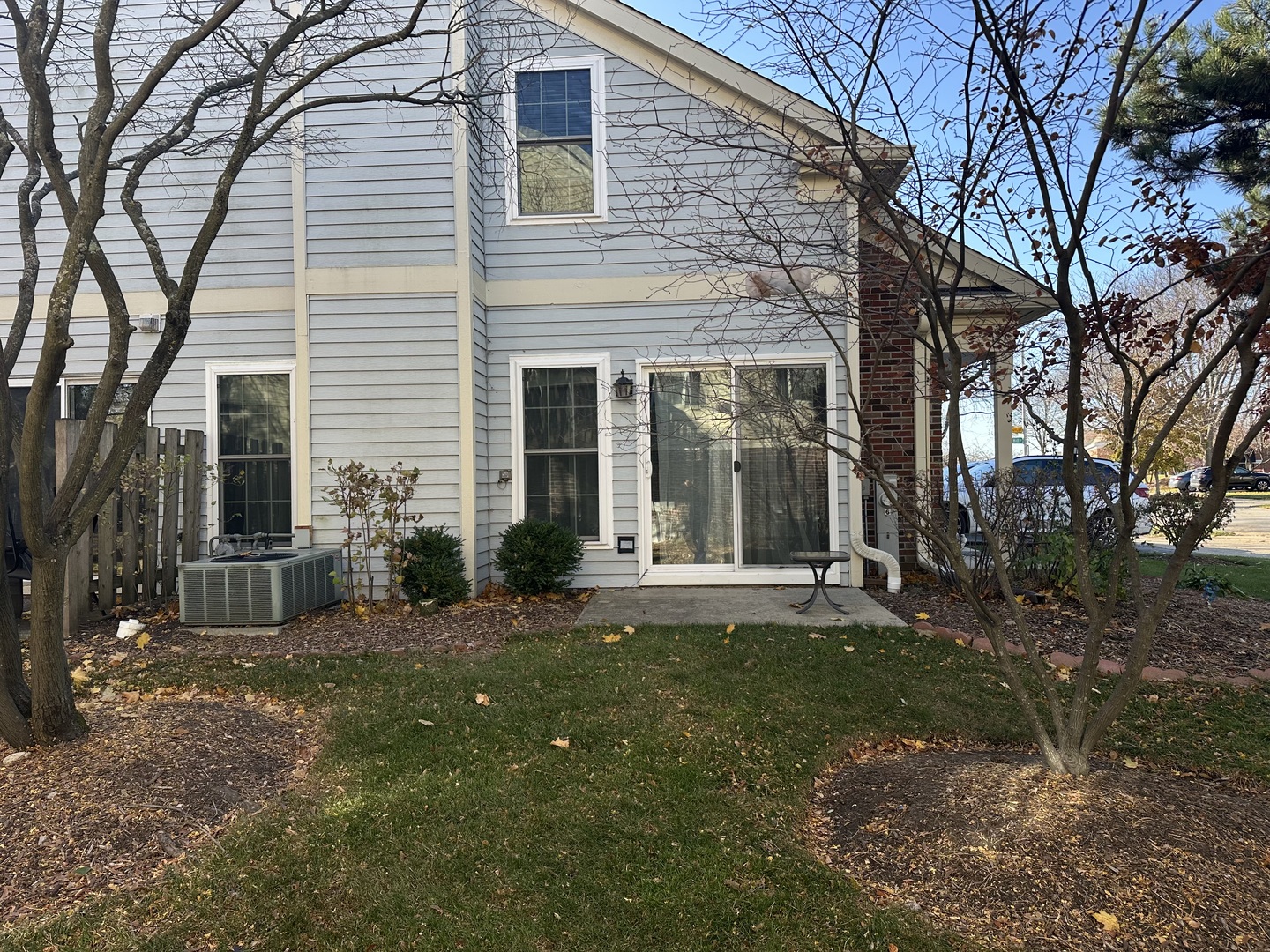 1063 Stillwater Road, Unit 1063 Elgin, IL 60120 - Photo 17 of 17 a view of a brick house with a large trees