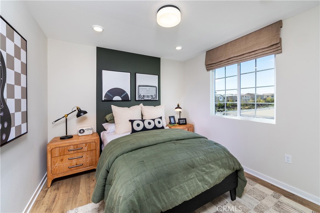 9568 Glenmore Frst Drive Riverside, CA 92508 - Photo 6 of 12 a bedroom with a bed and wooden floor