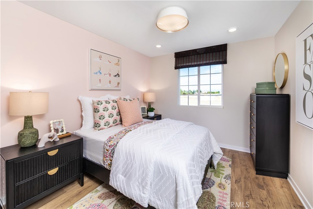9568 Glenmore Frst Drive Riverside, CA 92508 - Photo 7 of 12 a bedroom with a bed and wooden floor