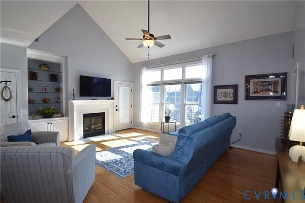 a living room with furniture a fireplace and a flat screen tv
