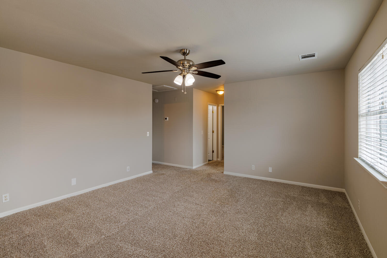 11402 Marshall Street Manor, TX 78653 - Photo 17 of 34 Empty room featuring ceiling fan and light colored carpet