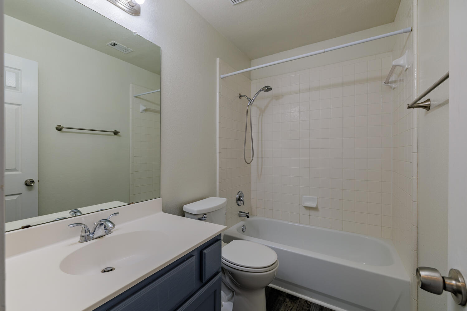 11402 Marshall Street Manor, TX 78653 - Photo 22 of 34 Bathroom featuring vanity, bathing tub / shower combination, and wood finished floors