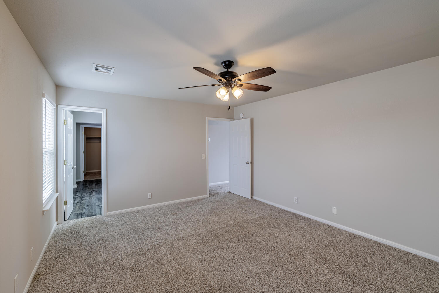 11402 Marshall Street Manor, TX 78653 - Photo 25 of 34 Unfurnished bedroom featuring a spacious closet, a ceiling fan, and carpet floors
