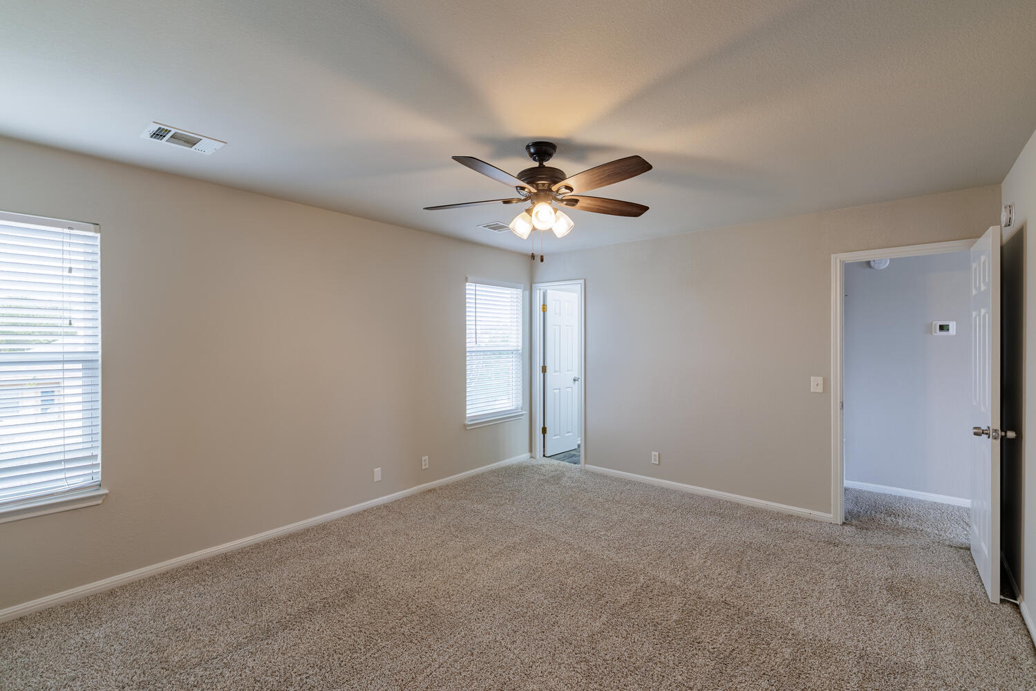 11402 Marshall Street Manor, TX 78653 - Photo 26 of 34 Carpeted spare room featuring baseboards and a ceiling fan