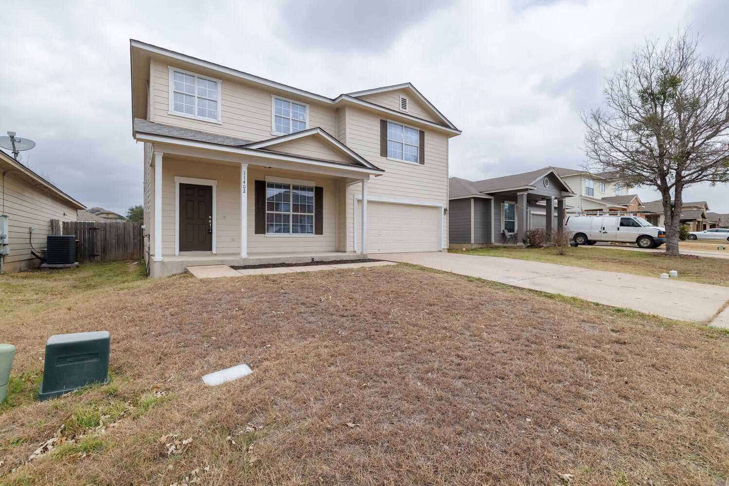 11402 Marshall Street Manor, TX 78653 - Photo 3 of 34 Traditional-style house with an attached garage, driveway, and a porch