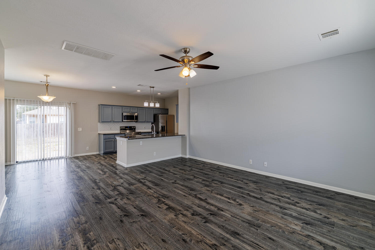 11402 Marshall Street Manor, TX 78653 - Photo 4 of 34 Unfurnished living room with ceiling fan, dark wood-style flooring, and recessed lighting
