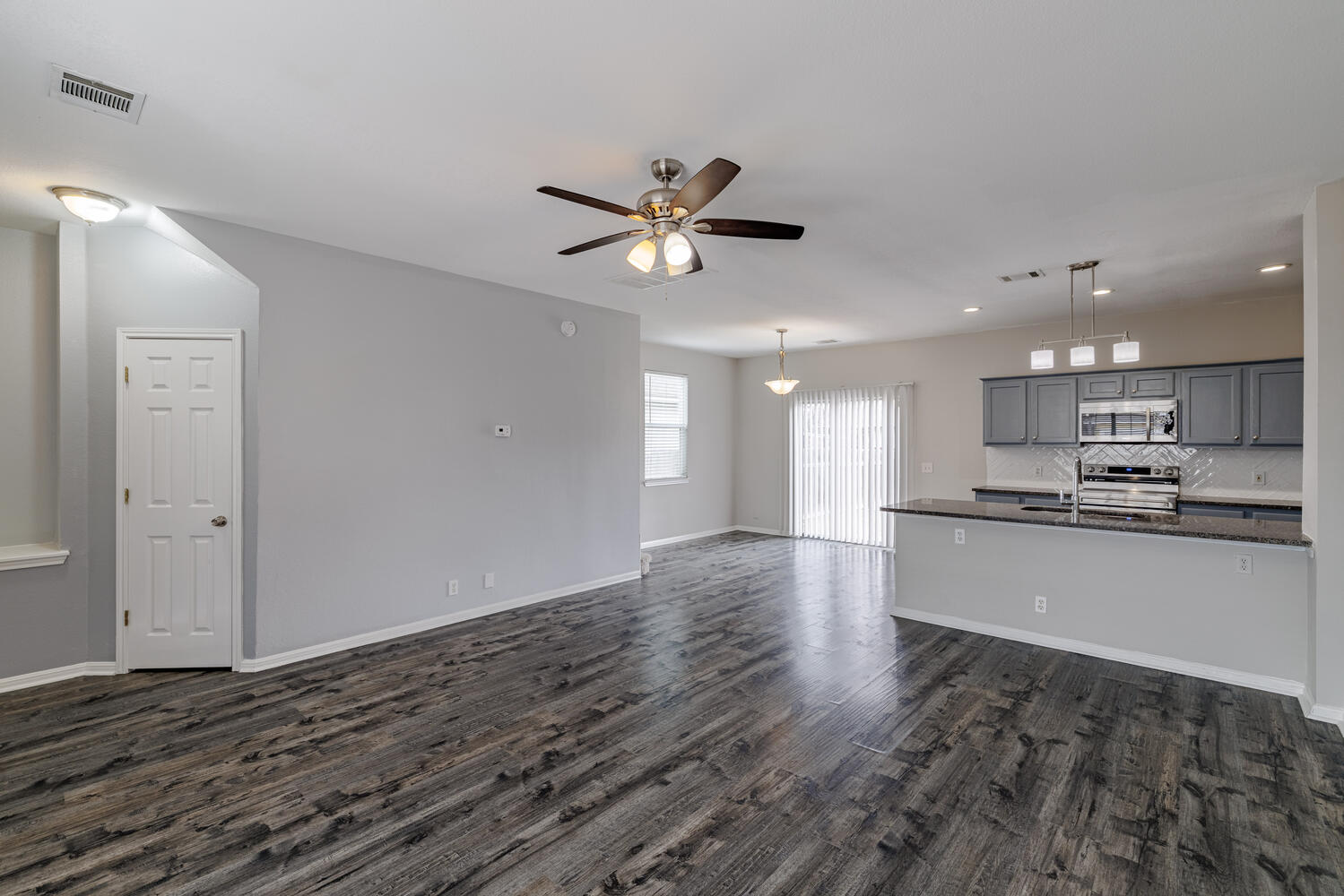 11402 Marshall Street Manor, TX 78653 - Photo 5 of 34 Unfurnished living room featuring a ceiling fan, dark wood-style floors, and recessed lighting
