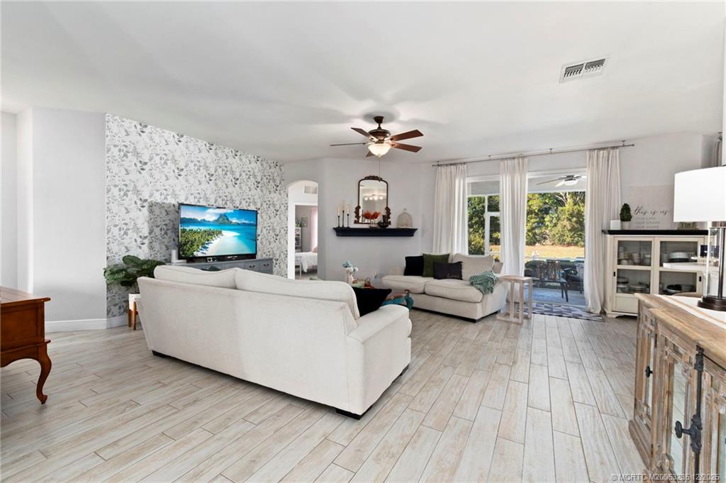 801 Southwest Tulip Boulevard Port St. Lucie, FL 34953 - Photo 15 of 41 a living room with furniture and a fireplace