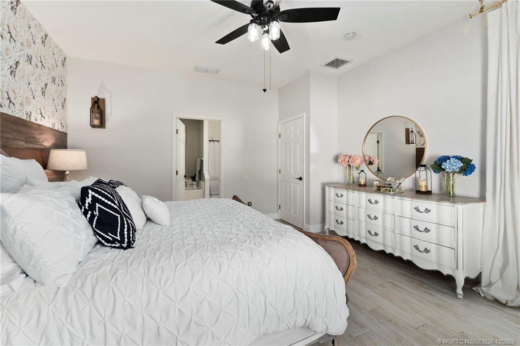 801 Southwest Tulip Boulevard Port St. Lucie, FL 34953 - Photo 27 of 41 a bedroom with a bed and a dresser