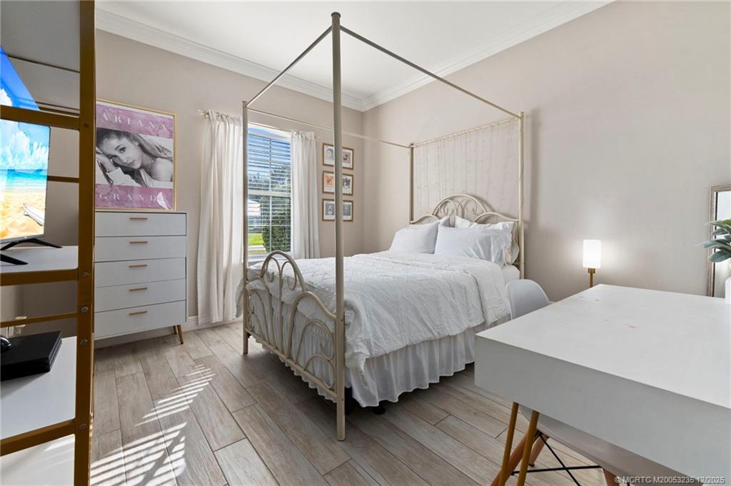 801 Southwest Tulip Boulevard Port St. Lucie, FL 34953 - Photo 32 of 41 a bedroom with double bed and a window