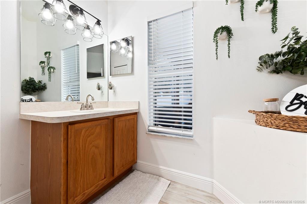 801 Southwest Tulip Boulevard Port St. Lucie, FL 34953 - Photo 36 of 41 a bathroom with a sink and a mirror