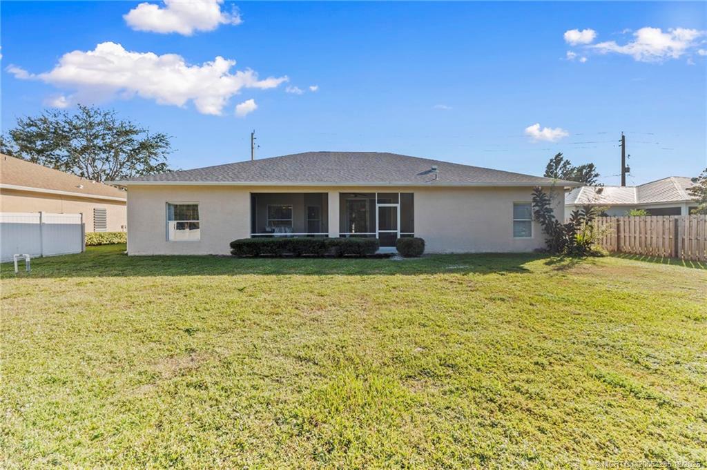 801 Southwest Tulip Boulevard Port St. Lucie, FL 34953 - Photo 40 of 41 a view of a house with a yard